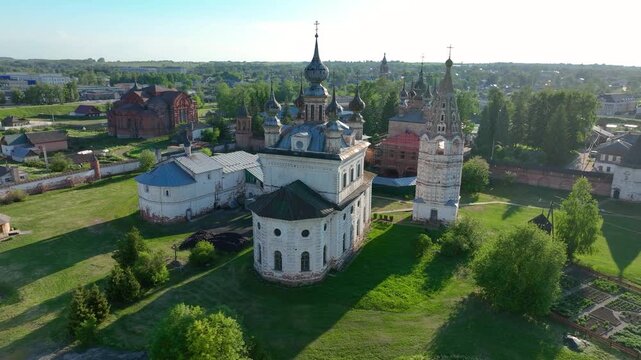 Aerial view of the Spaso Yevfimiyev Monastery complex showing a wooden house, white bell tower, and the main Orthodox church with domes