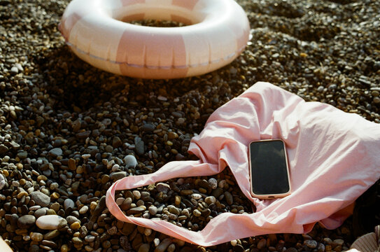 Bright summer day at the beach with a pink swimming tube