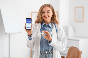 Female doctor with mobile phone and glucose sensor measuring blood sugar level in office