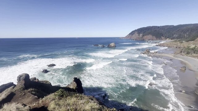 A breathtaking aerial panorama capturing the curved coastline of Crescent Beach, framed by dramatic cliffs and forest, as seen from the elevated Ecola Point Viewpoint on the Oregon Coast