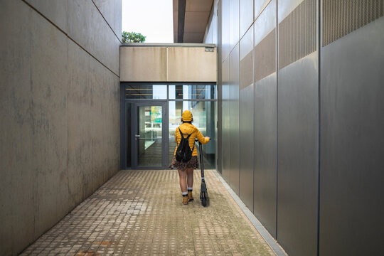 woman with electric scooter in the city