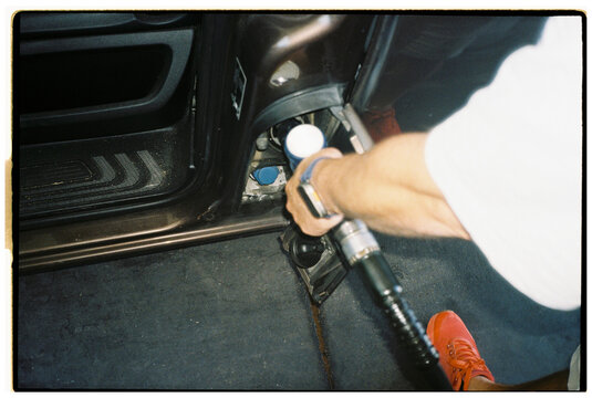 Close-up of man refueling car