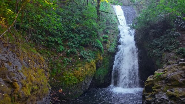 A beautiful view of Bridal Veil Falls, a distinctive two-tiered waterfall with a wispy, veil-like appearance, located near the historic Bridal Veil Falls State Scenic Viewpoint in the Columbia River G