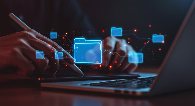 A person interacts with holographic digital file icons on a laptop, a conceptual representation of data management and technological integration.