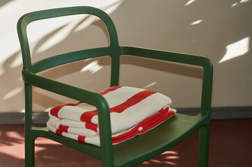 Bright white and red towels on a chair