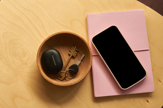 Everyday items arranged on a wooden table,