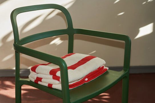 Bright white and red towels on a chair