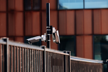 Security Cameras on Modern Fence