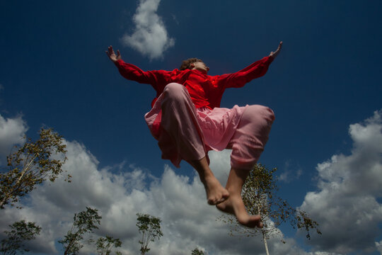 Dance in the pink dress in the sunlight 