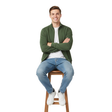 Confident young man casually sitting on a wooden stool with a warm smile isolated
