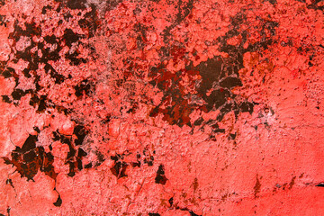 Peeled red paint on a dark background. Old Bright Red Texture