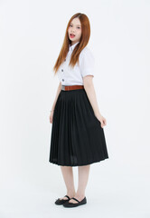 Studio portrait of asian cheerful beautiful happy young woman wearing white blouse, black pleated skirt, black flats posing on white background, university student uniform, education lifestyle concept