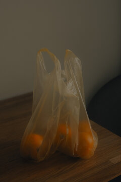 Bag of Yellow Tomatoes on a Wooden Table
