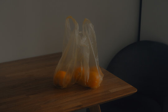 Bag of Yellow Tomatoes on a Wooden Table
