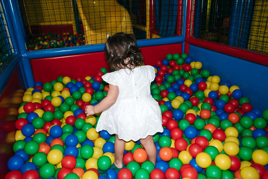 Anonymous girl playing in a ball pool
