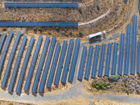 Rows of solar panels on a coastal hillside