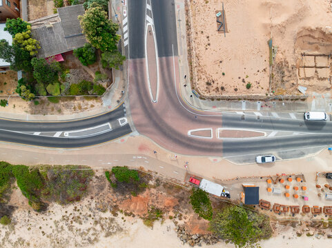 Divided road carriageways around a paved T intersection
