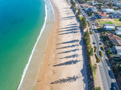 Turquoise sea off a sandy beach along a coastal esplande