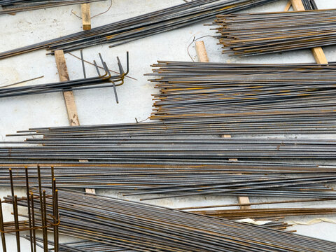Stacked Rusted Steel Rebar Rods and Cages on Construction Site