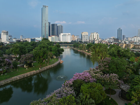 Hanoi lake with skyline and blooming park