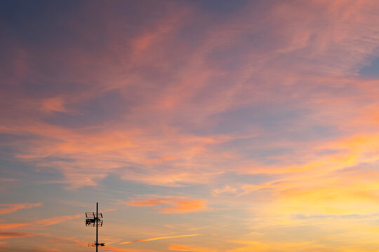 Beautiful Sunset With Colorful Clouds and Antenna Silhouette