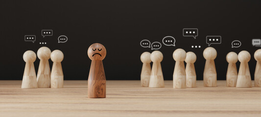 Sad wooden figure excluded from group. Concept of bullying, discrimination, isolation, loneliness,...