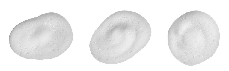 Close-up of white foam texture from skincare cleanser isolated on white background, showing soft bubbles and smooth texture for beauty, hygiene, and cosmetic product design concepts.