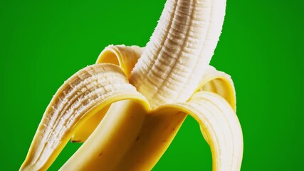 Close-up of peeled banana against vibrant green background, showcasing texture & freshness - Powered by Adobe