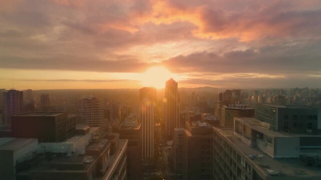 Vibrant city skyline at golden hour, illuminated by a breathtaking sunrise, casting warm light over towering urban architecture and a serene metropolis
