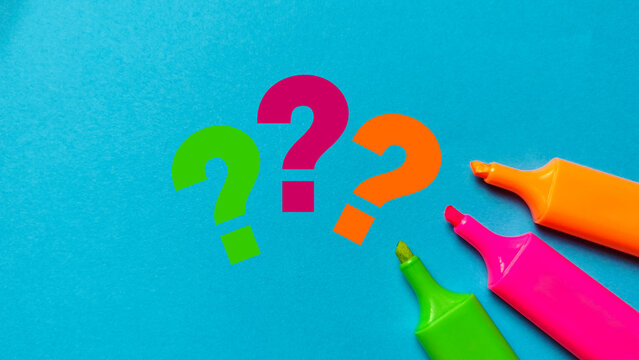 Colorful three question marks and highlighter pens on a bright blue background representing curiosity, doubt, decision making, and problem solving.