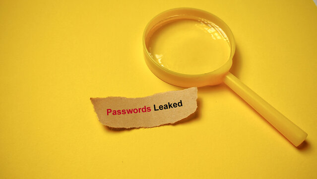 Magnifying glass investigating "Passwords Leaked" cyber security breach, symbolizing data risk, digital threat, and identity theft.