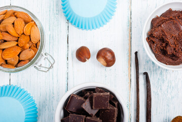 muffin baking ingredients on white wooden table