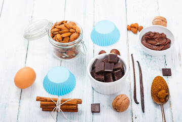 muffin baking ingredients on white wooden table