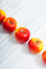 apple fruits in a row, white wooden table background