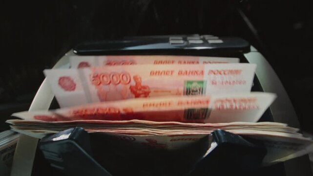 5000 Russian rubles in electronic money counting machine, accounting. Financial transaction in the bank. RUB Mortgage, Seller or broker considers finances. Economic crisis in Russia. Slow motion