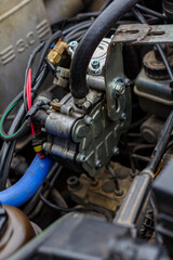 Close-up: Car Engine Compartment Components with Autogas LPG/CNG Conversion Kit, Wires and Hoses
