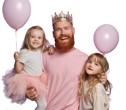happy father with crown and daughters with balloons