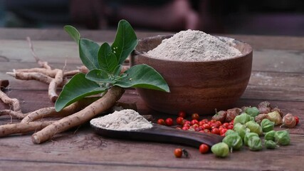 Ashwagandha Roots and powder known as Withania somnifera in white bowl on wooden background. Indian ginseng, poison gooseberry, or winter cherry. Herbal adaptogen ayurvedic medicine. - Powered by Adobe