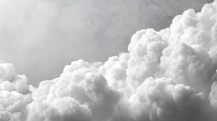Dense white cumulus clouds form a textured border against a muted gray sky