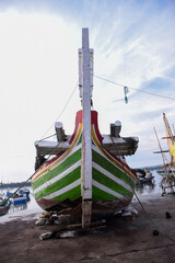 The bow of a fishing boat being repaired at the harbor.