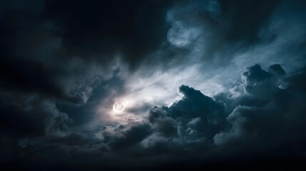 Obraz premium Dramatic solar eclipse revealed through dark stormy clouds highlighting the sun s bright corona ring