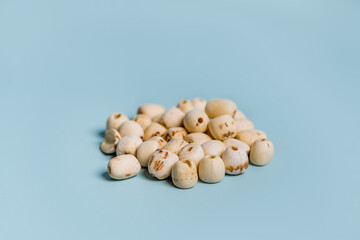 Dried lotus seeds for food on a blue background