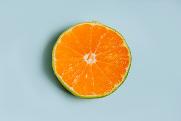 Ripe tangerines with green peel and orange flesh