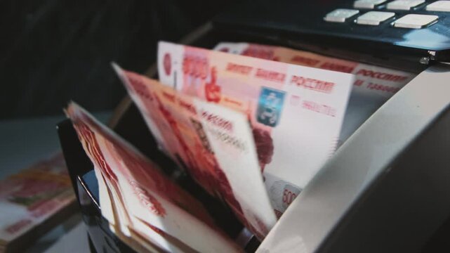 5000 Russian rubles in electronic money counting machine, accounting. Financial transaction in the bank. RUB Mortgage, Seller or broker considers finances. Economic crisis in Russia. Slow motion