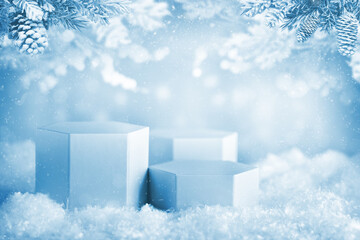Winter Scene with Hexagon light blue podiums in snowy scenery under frosted pine branches, ideal for product displays or seasonal advertising.