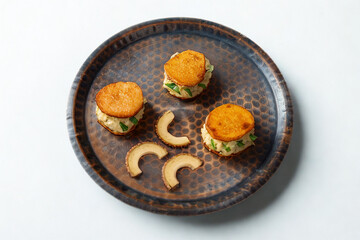 Artfully arranged appetizers with orange topping on a textured plate