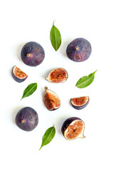 Purple ripe figs fruit and slices with green leaves top view on a white background