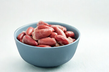 Bowl of raw kidney beans against a white background