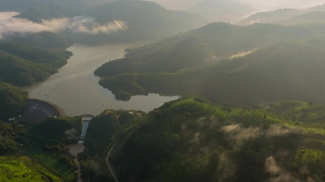 Drone video of Presa EL Carrizo, Tamazula de Gordiano, Jalisco, showcases breathtaking landscapes at sunrise. Misty hills and tranquil waters form a serene, natural panorama.
