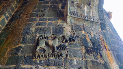 stone carving at entrance of the janjira fort in murud in maharashtra in india.